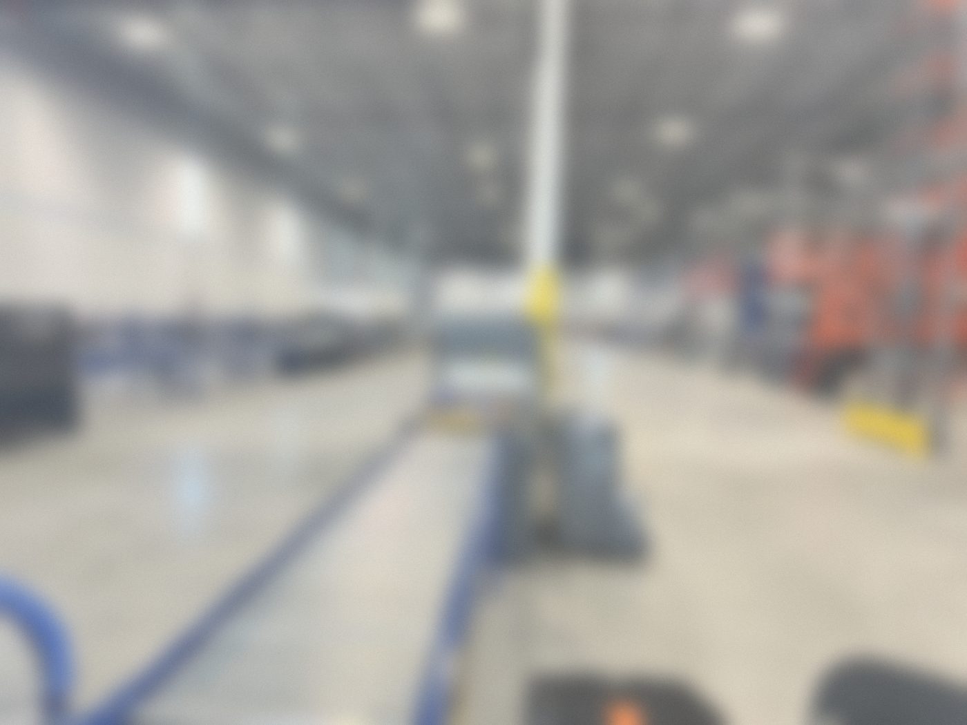 Roller conveyor leading to packaging equipment in a large facility