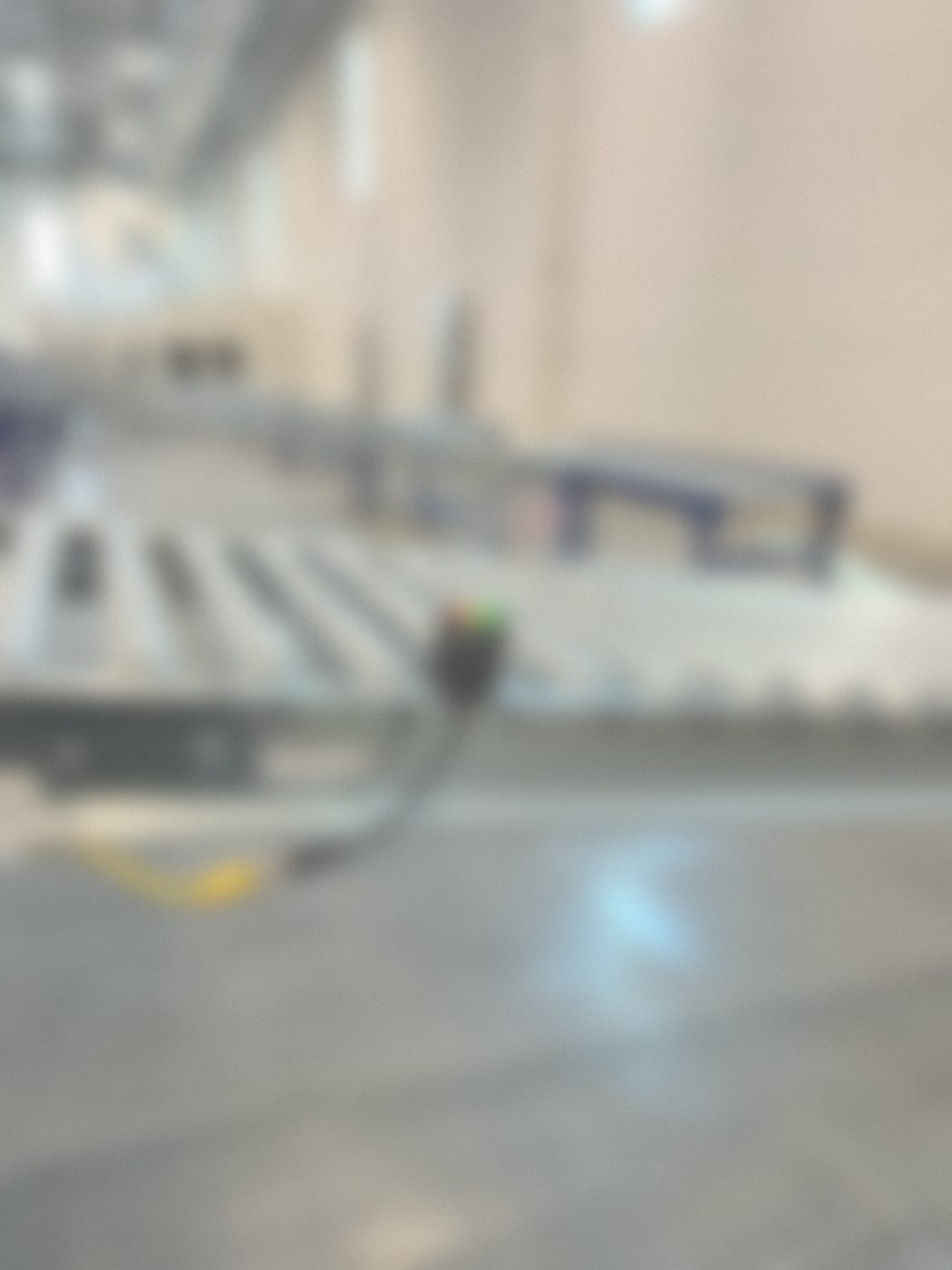 Photo eye with a quick-disconnect cord on a roller conveyor frame